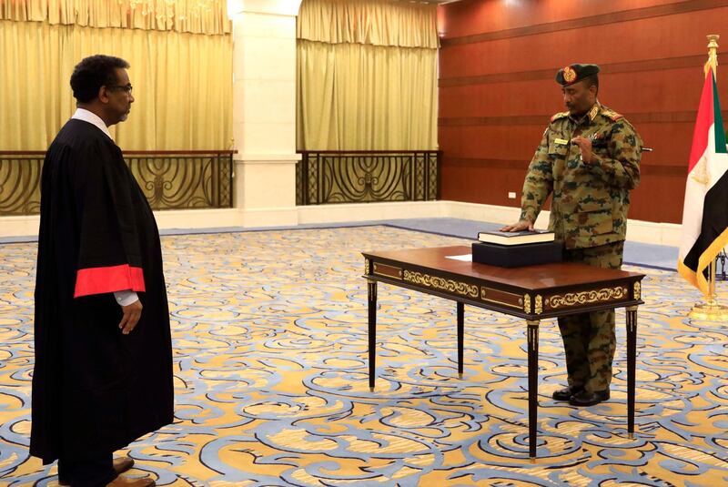 epa07783624 Leader of Sudan's transitional council, Lieutenant General Abdel Fattah Abdelrahman Burhan (R) is sworn in as the Head of the newly formed transitional Council at the presidential palace in Khartoum, Sudan, 21 August 2019. The Sudanese opposition and military council signed on 17 August a power sharing agreement. The agreement sets up a sovereign council made of five generals and six civilians, to rule the country until general elections. Protests had erupted in Sudan at the end of 2018, culminating in a long sit-in outside the army headquarters which ended with more than one hundred people being killed and others injured. Sudanese President Omar Hassan al-Bashir stepped down on 11 April 2019.  EPA/STRINGER