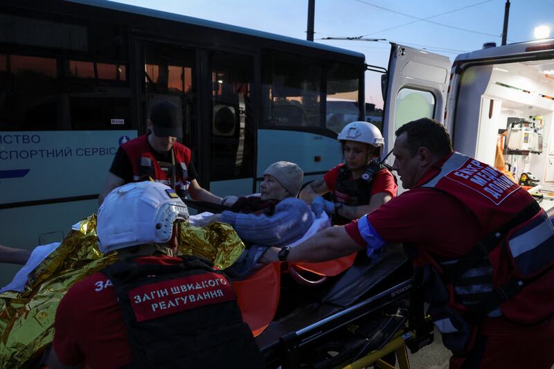 An elderly woman is evacuated from a flooded area in Kherson. Reuters