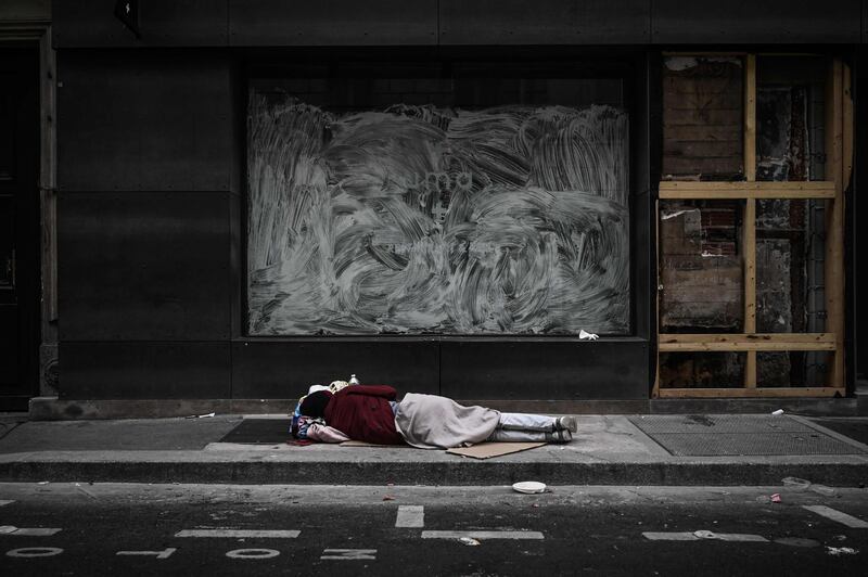 A homeless sleeps in front of closed shops in Paris, France. AFP