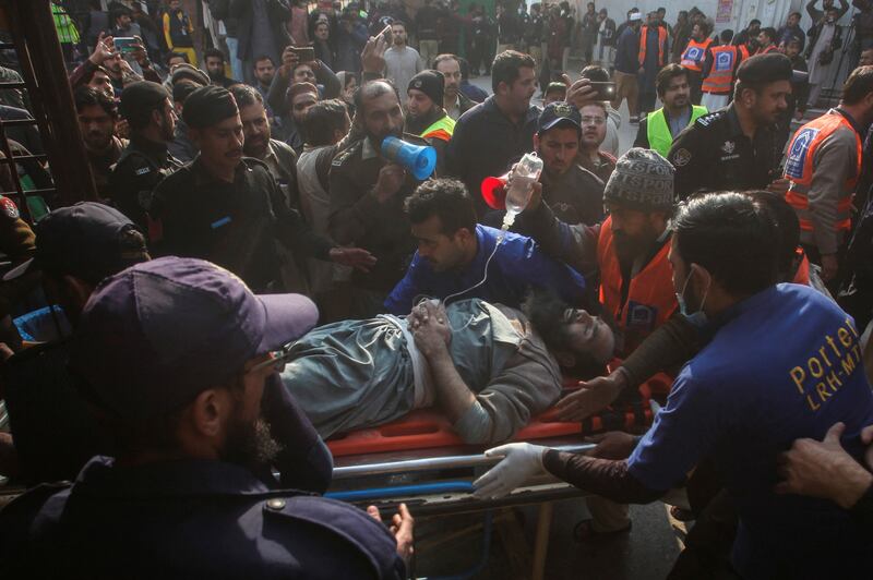 People move a worshipper hurt in the blast. Reuters