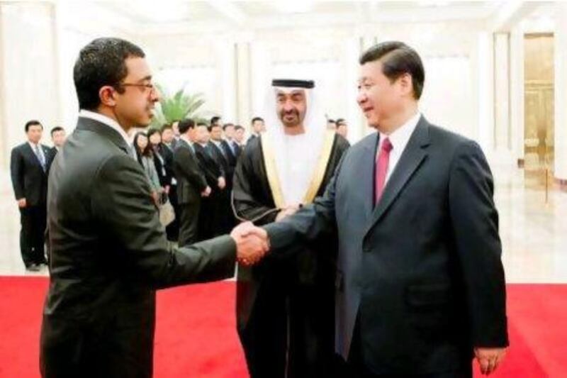 Sheikh Mohammed bin Zayed, centre, and Sheikh Abdullah bin Zayed, Minister of Foreign Affairs, greet Xi Jinping, China's vice president, in Beijing yesterday.