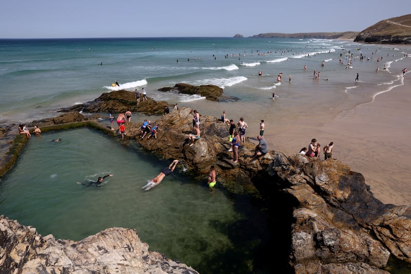 Bathers keep cool in a tidal pool at Perranporth Beach in Cornwall, south-west England. Reuters