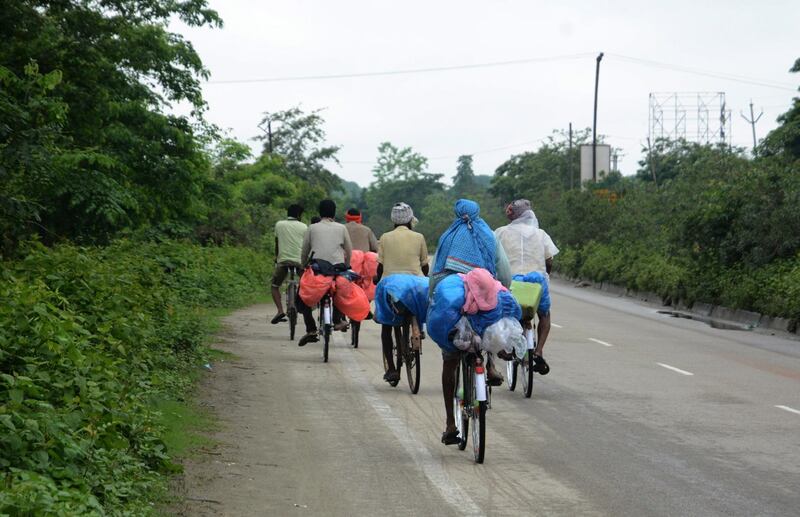 Workers on bicycles on their way to their native places in Bihar from Golaghat district, at Nalbari district of Assam, May 24. EPA