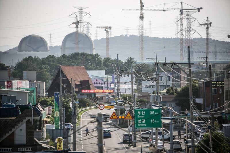 Power cables line a street as the Shin Kori No. 3 and 4 nuclear power reactors, operated by Korea Hydro & Nuclear Power Co., a unit of Korea Electric Power Corp. (Kepco), rear left, stand next to the construction site for the Shin Kori No. 5 and 6 reactors, rear right, in Ulju, Ulsan province, South Korea, on Thursday, Aug. 31, 2017. South Korea has the world’s sixth-largest nuclear energy program, with 24 facilities running and five under construction including the two in Ulju, which are about 30 percent complete. Photographer: Jean Chung/Bloomberg
