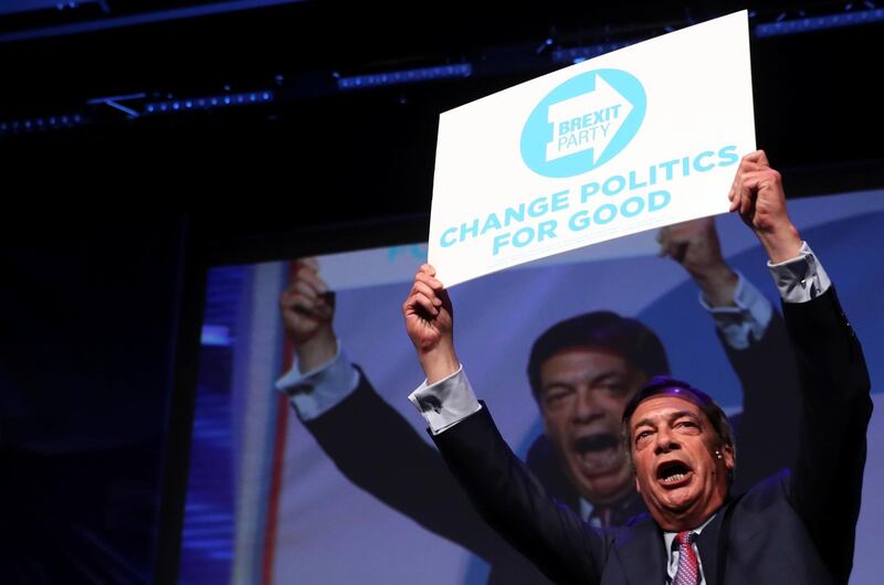 Brexit Party leader Nigel Farage holds up a placard during a rally in Peterborough, Britain May 7, 2019. REUTERS/Simon Dawson