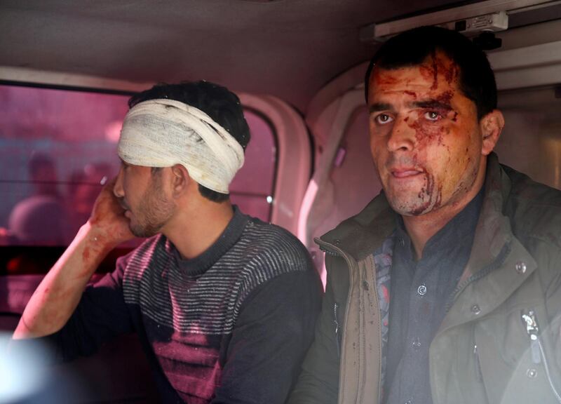 Injured men sit in an ambulance after a blast in Kabul, Afghanistan. Mohammad Ismail / Reuters