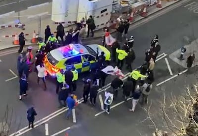 Clashes between police and protesters in Westminster on February 7 as officers use a police car to escort Labour leader Sir Keir Starmer to safety.