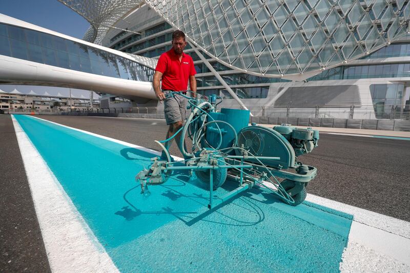 A worker applying paint to Yas Marina Circuit. Courtesy Seven Media
