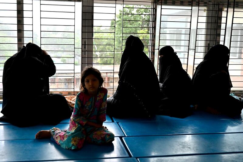 Women shelter with their children on Shahpori island. AFP