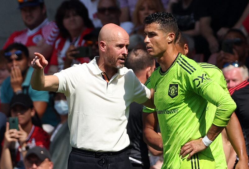 Manchester United's Dutch manager Erik ten Hag (L) directs substitute Manchester United's Portuguese striker Cristiano Ronaldo during the English Premier League football match between Southampton and Manchester United at St Mary's Stadium in Southampton, southern England on August 27, 2022.  (Photo by Adrian DENNIS / AFP) / RESTRICTED TO EDITORIAL USE.  No use with unauthorized audio, video, data, fixture lists, club/league logos or 'live' services.  Online in-match use limited to 120 images.  An additional 40 images may be used in extra time.  No video emulation.  Social media in-match use limited to 120 images.  An additional 40 images may be used in extra time.  No use in betting publications, games or single club/league/player publications.   /  