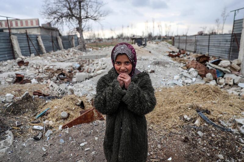 epa07078136 A displaced Syrian girl Shaimaa stands among the rubbles next to her shelter in al-Asha'ari, Eastern al-Ghouta, Syria, 18 January 2018. Many Syrian families were forced to left their homes and villages on a frontline in Eastern al-Ghouta. According to reports Eastern Ghouta was hit with continuing airstrikes for more than 16 past days in a row.  EPA/MOHAMMED BADRA