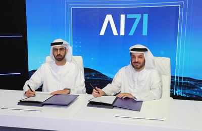 Omar Al Olama, Minister of State for Artificial Intelligence, Digital Economy and Remote Work Applications, and Faisal Al Bannai, secretary general of the Advanced Technology Research Council, sign the agreement. Pawan Singh / The National