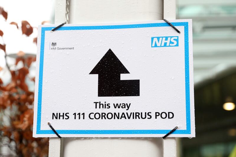 A sign from England's National Health Service directs individuals with coronavirus-like symptoms towards a designated 'pod', where they can speak to doctors, outside University College Hospital in London on March 5, 2020. The number of confirmed coronavirus cases in the UK rose to 90 on Thursday. Isabel Infantes / AFP