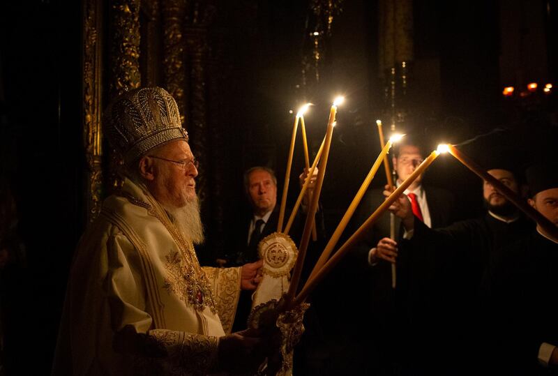 Ecumenical Patriarch Bartholomew I, left, the spiritual leader of the world's Orthodox Christians, leads the service for the Resurrection of Christ during Orthodox Easter Week services, held without worshippers to help contain the spread of the coronavirus at the Patriarchal Church of St George in Istanbul. AP