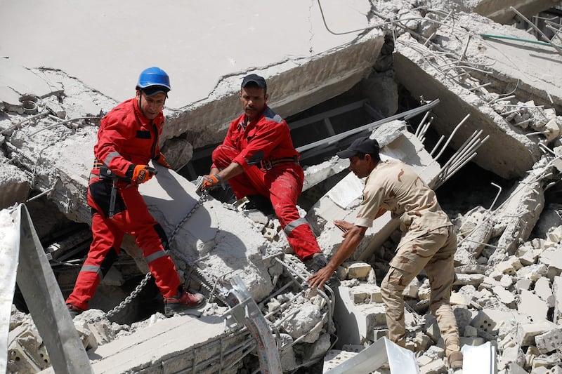 Iraqi emergency responders search for survivors in the rubble. AFP