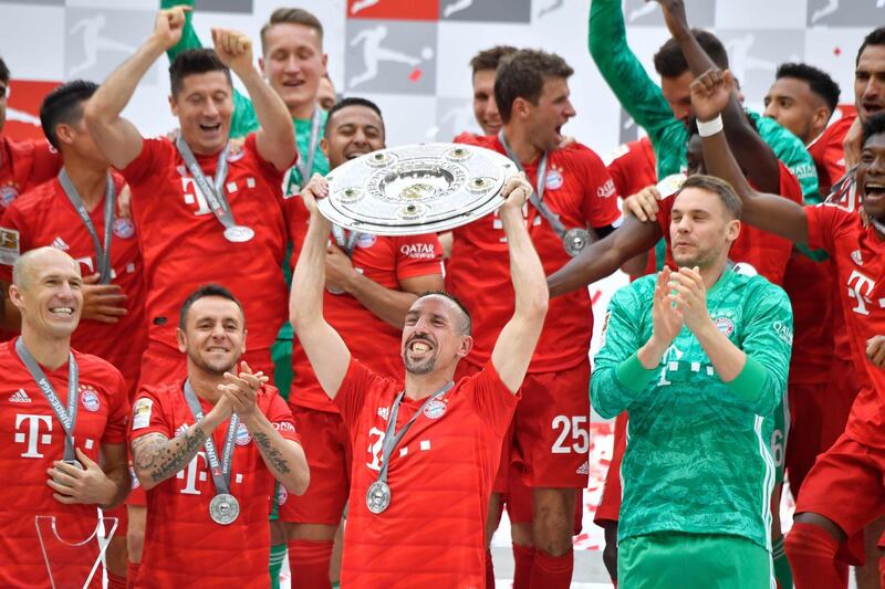 Bayern Munich players including Bayern Munich's French midfielder Franck Ribery celebrate with the trophy after the German First division Bundesliga football match FC Bayern Munich v Eintracht Frankfurt in Munich, southern Germany,  on May 18, 2019. DFL REGULATIONS PROHIBIT ANY USE OF PHOTOGRAPHS AS IMAGE SEQUENCES AND/OR QUASI-VIDEO 
 / AFP / John MACDOUGALL / DFL REGULATIONS PROHIBIT ANY USE OF PHOTOGRAPHS AS IMAGE SEQUENCES AND/OR QUASI-VIDEO 
