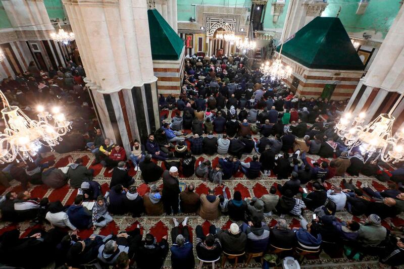 Palestinian Muslim worshippers gather for an early morning prayer at the Ibrahimi mosque, also known as the Tomb of the Patriarch -- a site holy to both Muslims and Jews where biblical patriarch Abraham is believed to have been buried, in the flashpoint city of Hebron in the occupied West Bank.  AFP