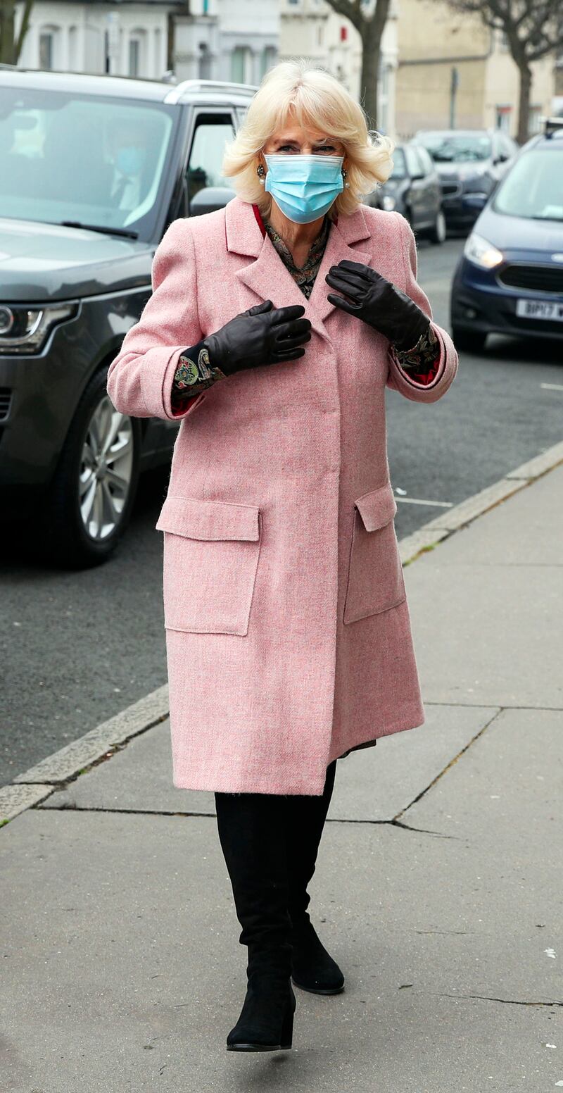 The queen consort, in a pink tweed coat and black boots, visits the Community Vaccination Centre at St Paul's Church on March 3, 2021 in Croydon, England. Getty Images