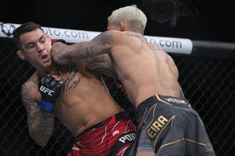 Charles Oliveira moves in with an elbow hit against Dustin Poirier. Reuters
