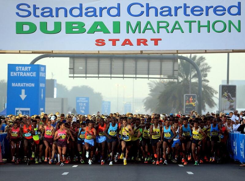 Runners cross the start line of the Standard Chartered Dubai Marathon in Dubai, United Arab Emirates, Friday Jan. 24, 2014. (STR) 