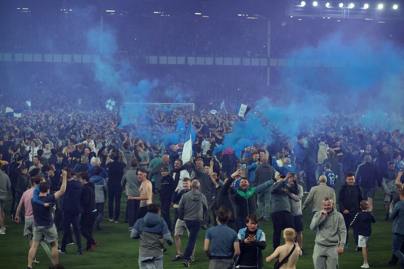 Everton fans invade the pitch after the match. Reuters