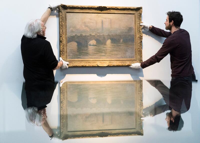 Museum technicians hang the painting 'Waterloo Bridge' by French painter Claude Monet, before the opening of the exhibition 'Gurlitt: Status Report Part 2 Nazi Art Theft and its Consequences' at the Kunstmuseum in Bern, Switzerland. Peter Klauzner / EPA