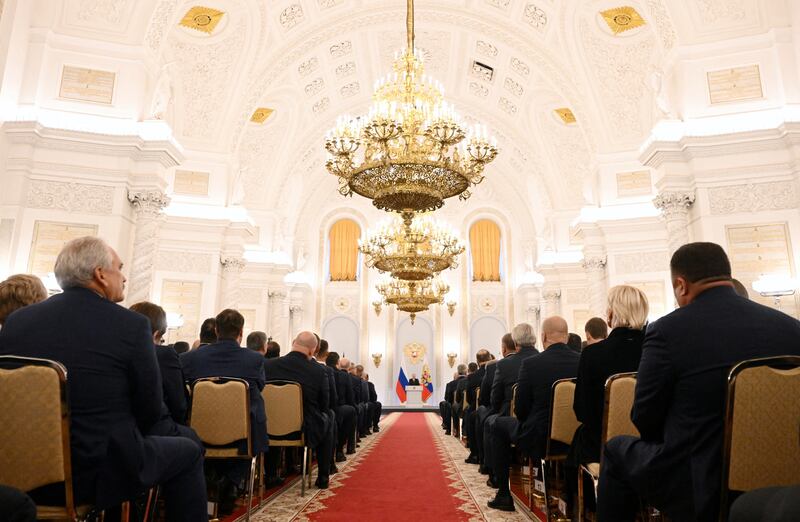 Participants listen to Mr Putin at the ceremony in the Georgievsky Hall of the Great Kremlin Palace in Moscow. Reuters