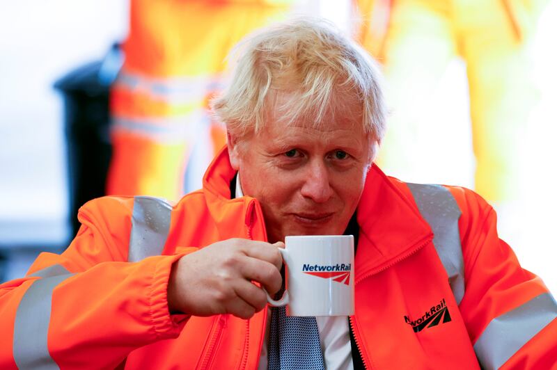 UK Prime Minister Boris Johnson drinks a cup of tea during a visit to a building site in Manchester, England, on Monday. Photo: Getty