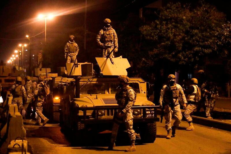 Lebanese security forces stand guard during clashes with anti-government protesters in the northern city of Tripoli, on January 29, 2021. AFP