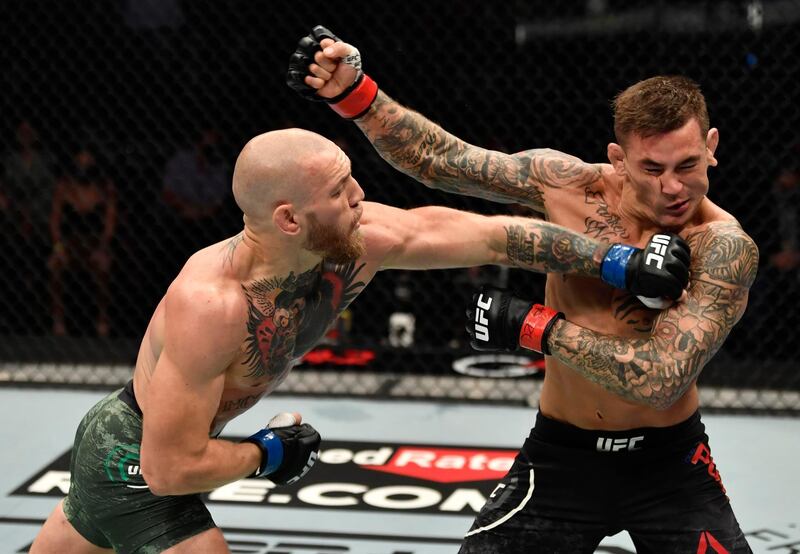 ABU DHABI, UNITED ARAB EMIRATES - JANUARY 23: (L-R) Conor McGregor of Ireland punches Dustin Poirier in a lightweight fight during the UFC 257 event inside Etihad Arena on UFC Fight Island on January 23, 2021 in Abu Dhabi, United Arab Emirates. (Photo by Jeff Bottari/Zuffa LLC)
