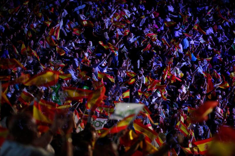 People wave Spanish flags during a rally of the fledging far-right party VOX in Madrid, Spain, Sunday, Oct. 7, 2018. Thousands of Spaniards have attended a rally of the fledging far-right party VOX as it tries to grab a foothold in Spain's political spectrum. (AP Photo/Manu Fernandez)