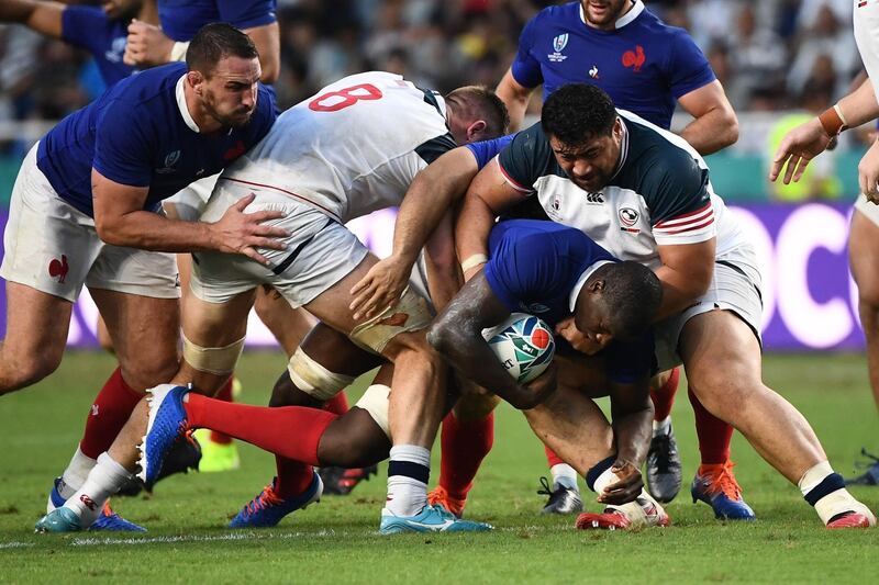 TOPSHOT - France's flanker Yacouba Camara (2R) is tackled by US prop Titi Lamositele (R) during the Japan 2019 Rugby World Cup Pool C match between France and the United States at the Fukuoka Hakatanomori Stadium in Fukuoka. AFP