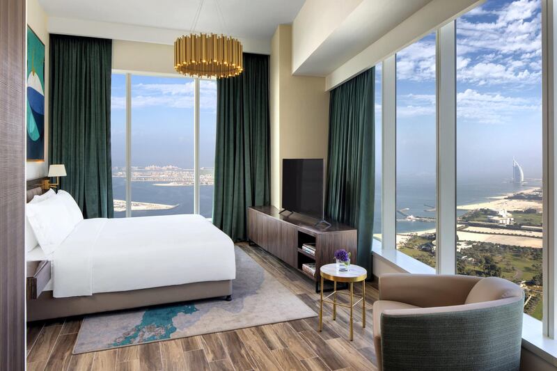 All rooms and suites have sleek interiors and floor-to-ceiling windows. 