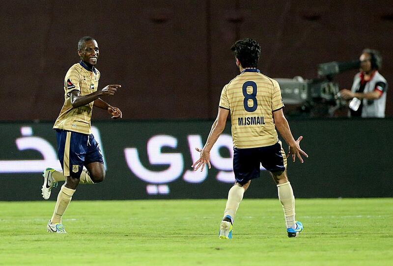 Gilles Yapo, left, of Dubai, celebrates after scoring a  goal against Al Jazira earlier in the Arabian Gulf League season. Goals have been few and far between for the club this year. Satish Kumar / The National