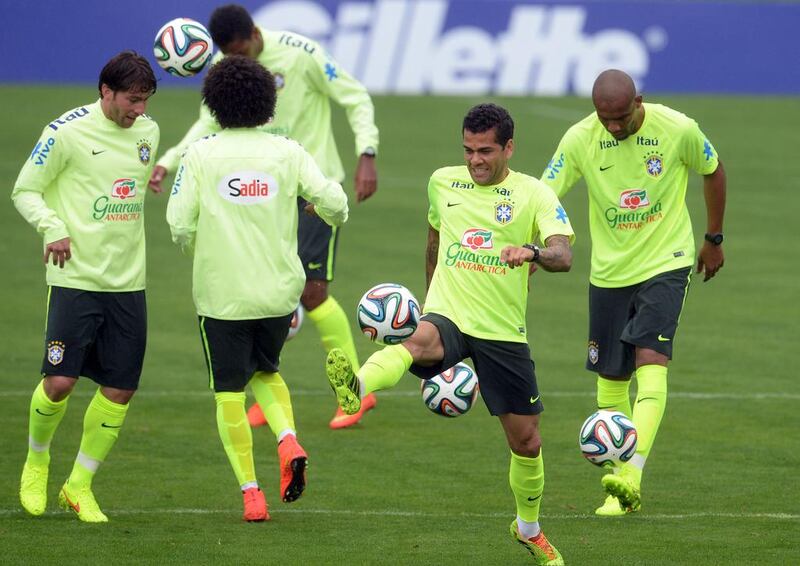 Footballer Dani Alves, second right, juggles with the ball during a training session of the Brazil national football team on Wednesday. Vanderlei Almeida / AFP / May 28, 2014