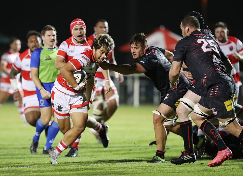 Dubai Tigers' Moli Schaumkel holds off a tackle during the game against Dubai Exiles.