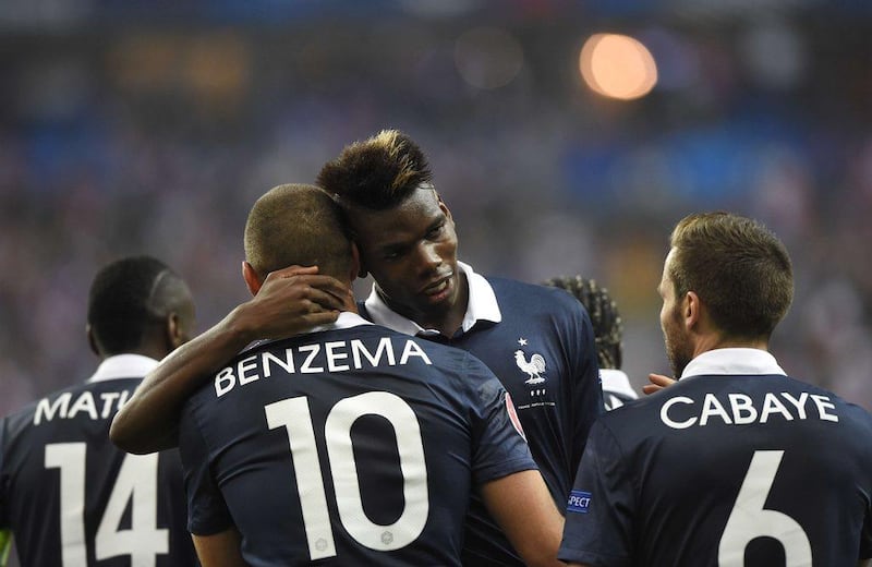 France's Paul Pogba celebrates with Karim Benzema after scoring a goal in their team's 2-1 win over Portugal in Paris on Saturday night. Franck Fife / AFP / October 11, 2014 