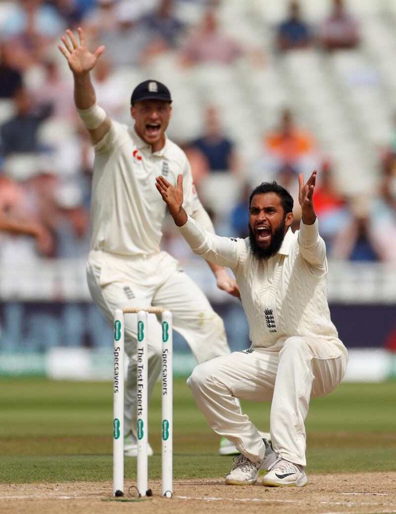 England's Adil Rashid celebrates the wicket of India's Ishant Sharma with his teammates. Reuters