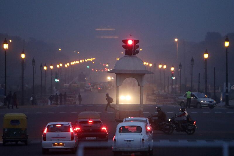 Traffic stands at a junction on King's Way boulevard while shrouded in smog at night in New Delhi, India. Anindito Mukherjee / Bloomberg
