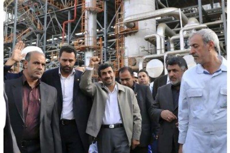 Mahmoud Ahmadinejad shows his delight during a tour of the Abadan oil refinery yesterday. The Iranian president's joy was short lived when a blast during his visit killed at least four people and wounded 25. Amir Pourmand / ISNA / AFP