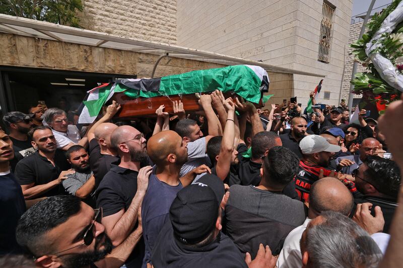 Palestinian mourners carry the casket of Abu Akleh out of a hospital before it is taken to a church. AFP
