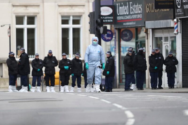Police officers work at the scene following a terror stabbing attack in the Streatham area of south London Monday Feb. 3, 2020. Police in London say the man identified as 20-year-old Sudesh Amman was wearing a fake bomb and stabbed two people Sunday before being shot to death by police was recently released from prison, where he was serving for terrorism offenses.(Aaron Chown/PA via AP)