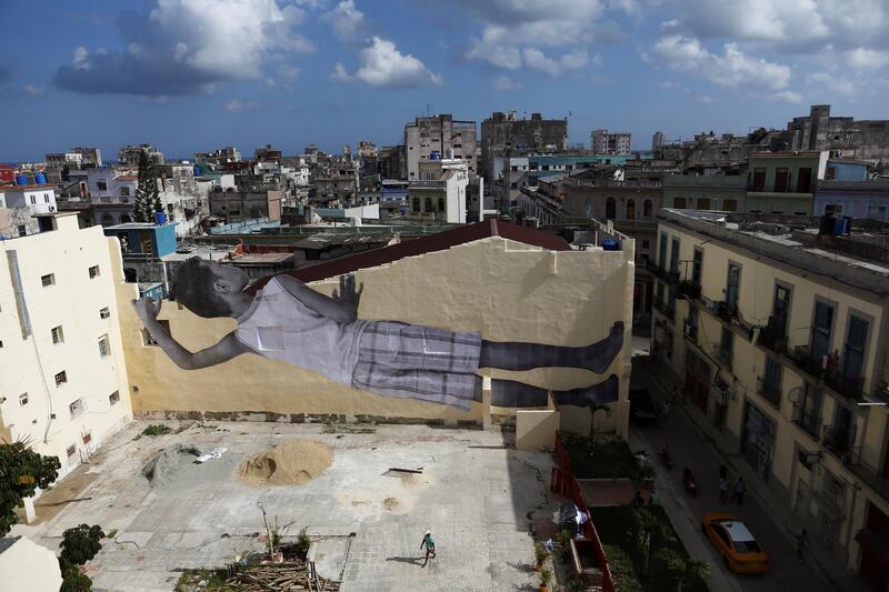 A giant photograph of a boy by French photographer and artist JR is seen on a wall. REUTERS