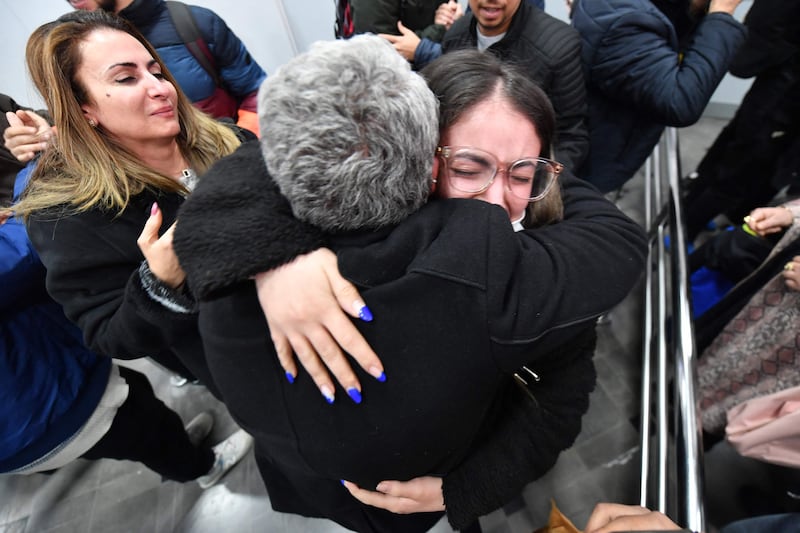 A student evacuated from Ukraine is embraced by her family after arriving at Tunis-Carthage International Airport in Tunisia. AFP