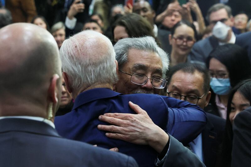 US President Joe Biden hugs a man in Monterey Park on March 14. Reuters