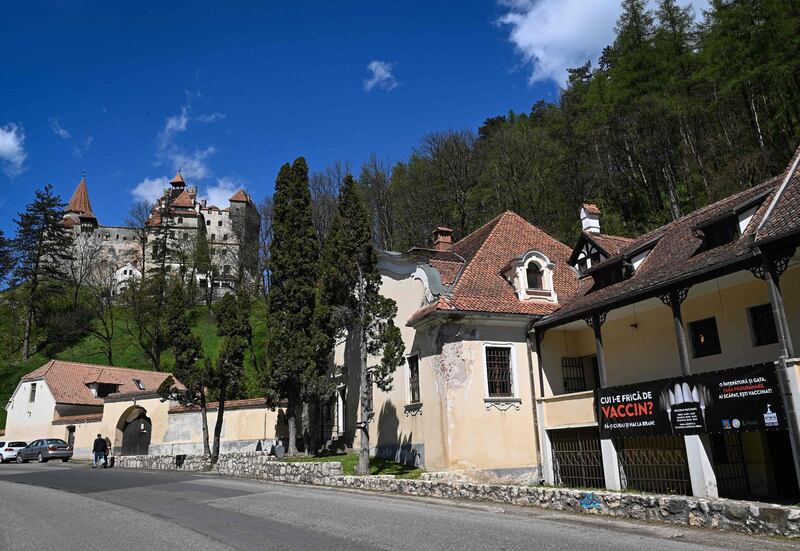 A banner reading in Romanian 'Who's afraid of [the] vaccine' advertises the vaccination marathon at Bran Castle in Bran village. AFP