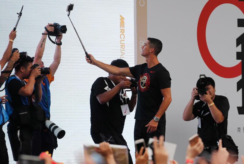 Ronaldo takes a selfie photo with fans. EPA