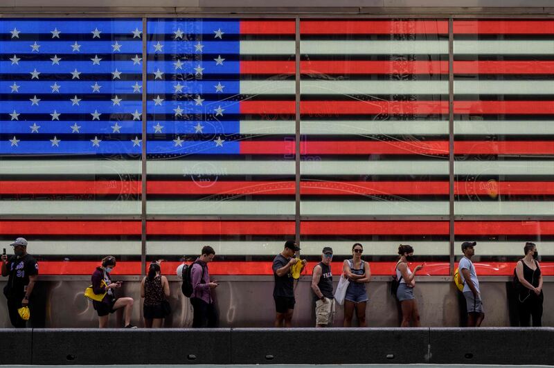 People queue to board a tourist bus in New York. About 3.8 million British nationals visited the US each year before the pandemic. AFP