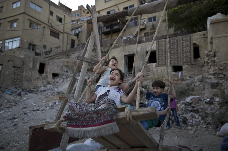 Jordanian children enjoy a ride on an improvised swing for the price of 25 piastres, (35 US cents) for 5 minutes, during Eid Al Fitr holiday, in Amman, Jordan. Muhammed Muheisen / AP photo