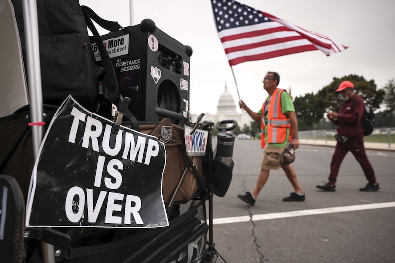 Supporters of those charged in the January 6 attack on the US Capitol walk past a counter-protest sign as they arrive for the "Justice for J6" rally near the US Capitol, September 18, 2021 in Washington. Getty / AFP